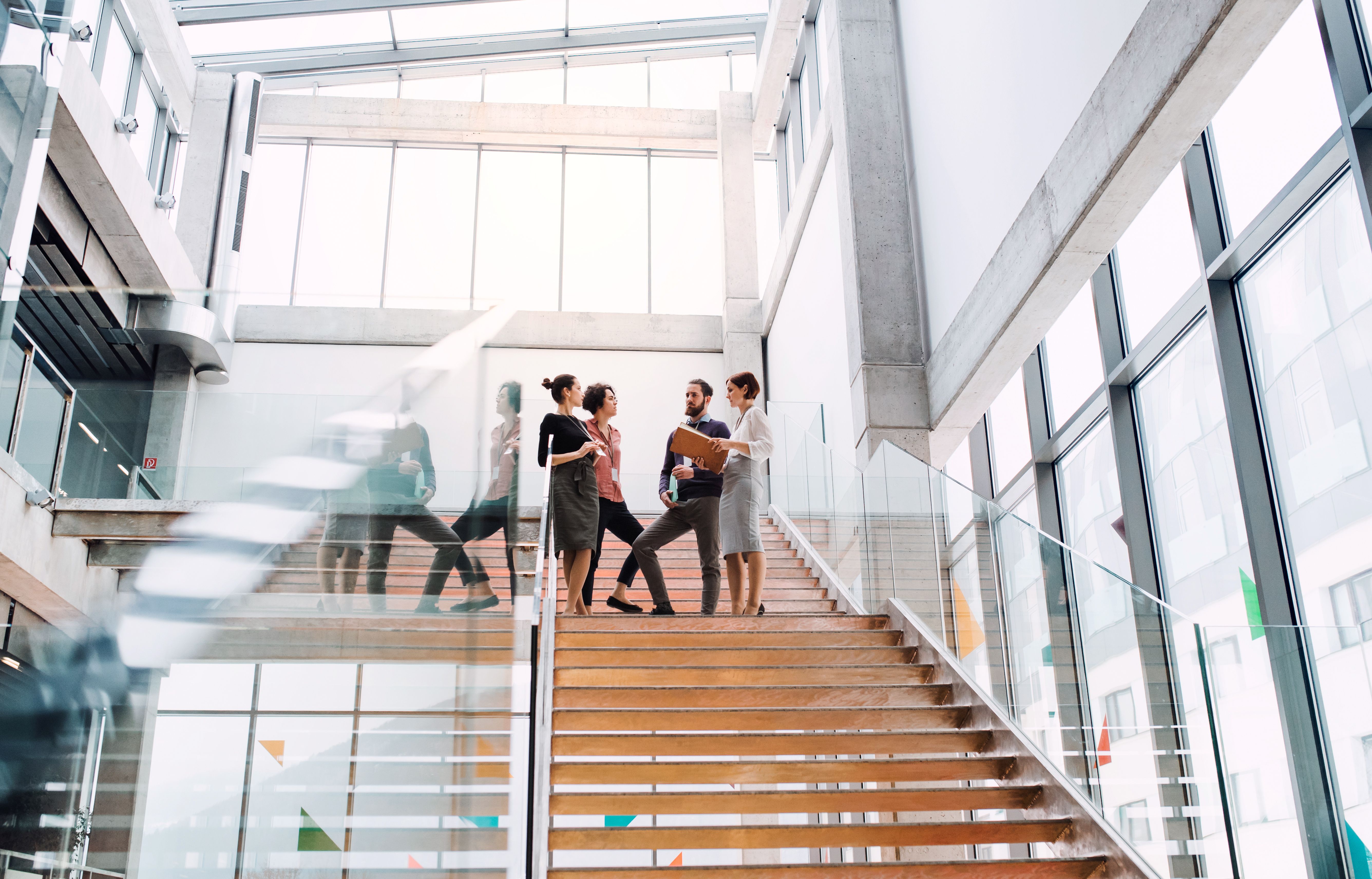 People talking on steps in office