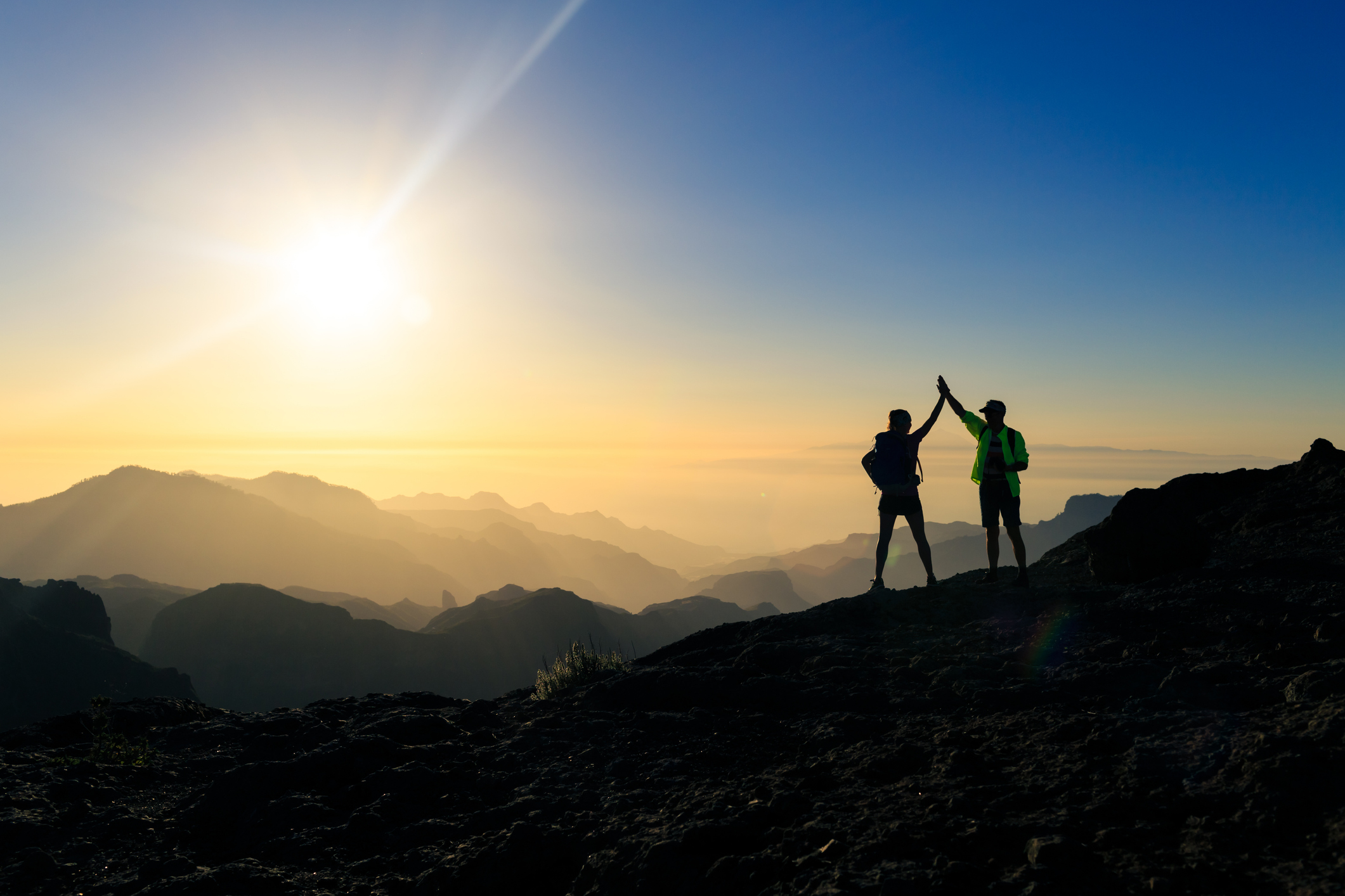People high fiving on a mountain
