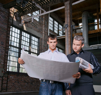 Two people looking at blueprints