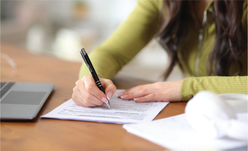 Woman writing on a paper