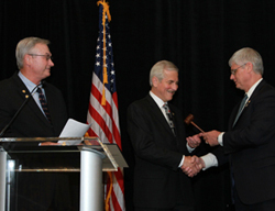 NSPE’s 2014–15 President Harve Hnatiuk, P.E., F.NSPE (center), receives the gavel from 2013–14 President Robert Green, P.E., F.NSPE, as 2012–13 President Dan Wittliff, P.E., F.NSPE, looks on.
