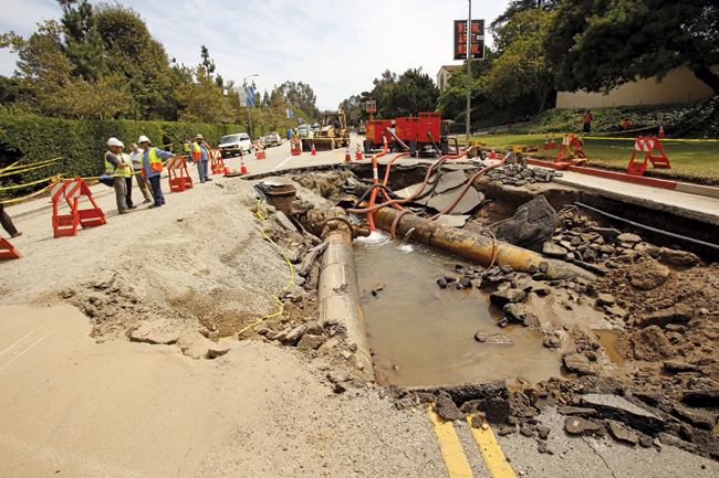 CREWS PREPARE FOR REPAVING SUNSET BOULEVARD NEAR THE UNIVERSITY OF CALIFORNIA, LOS ANGELES, WHERE AN UNDERGROUND WATER MAIN BREAK ON JULY 29 FLOODED PARTS OF THE CAMPUS.