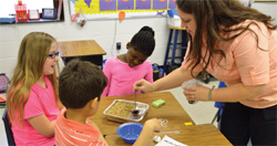 STUDENTS WORK ON A PROJECT RELATED TO OIL SPILLS IN A CLASSROOM USING THE ENGINEERING IS ELEMENTARY CURRICULUM. ENGINEERING IS ELEMENTARY