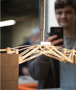 AT THE COLORADO HIGH SCHOOL BRIDGE BUILDING COMPETITION ON FEBRUARY 18, A COMPETITOR’S MODEL FEELS THE STRAIN.