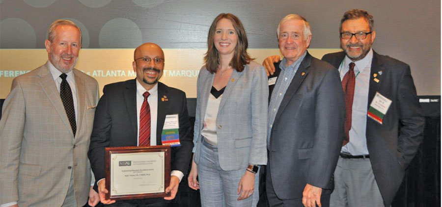 NADIR YILMAZ (SECOND FROM LEFT), CELEBRATED WITH (FROM LEFT) NSPE EXECUTIVE DIRECTOR MARK GOLDEN, 2016–2017 PRESIDENT KODI VERHALEN, P.E., ESQ., F.NSPE, 2017–2018 PRESIDENT TOM ROBERTS, P.E., F.NSPE, AND 2015 AWARD WINNER AND MENTOR AHMET ZEYTINCI, P.E., PH.D., F.NSPE.