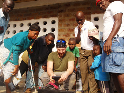 VIDA's solar consultant teaches the villagers how to read the battery power indicator.