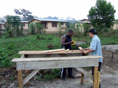 VIDA board members David Levine and Kosi Yinkah construct a box to house the battery that will charge from the solar panels.