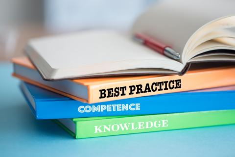 Stack of books on best practice, competence, knowledge