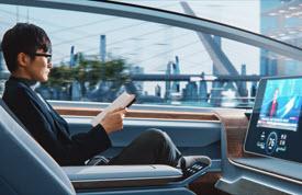 Person reading a paper while sitting in an autonomous vehicle.